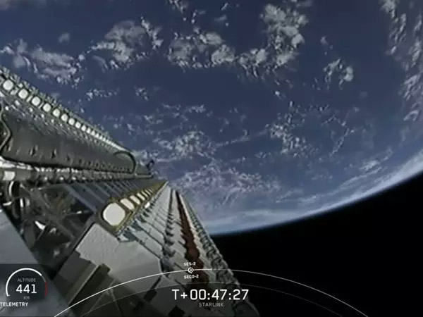 A frame from a live video feed shows a SpaceX Falcon 9 rocket delivering a starlink satellites into orbit ..