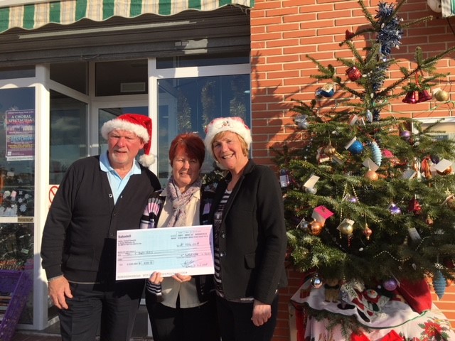 Mary Chambers, the representative of DEBRA receives a cheque for €1000 from Worshipful Brother Gordon Ramshead and his partner Sheila Fairbairn at their La Marina store