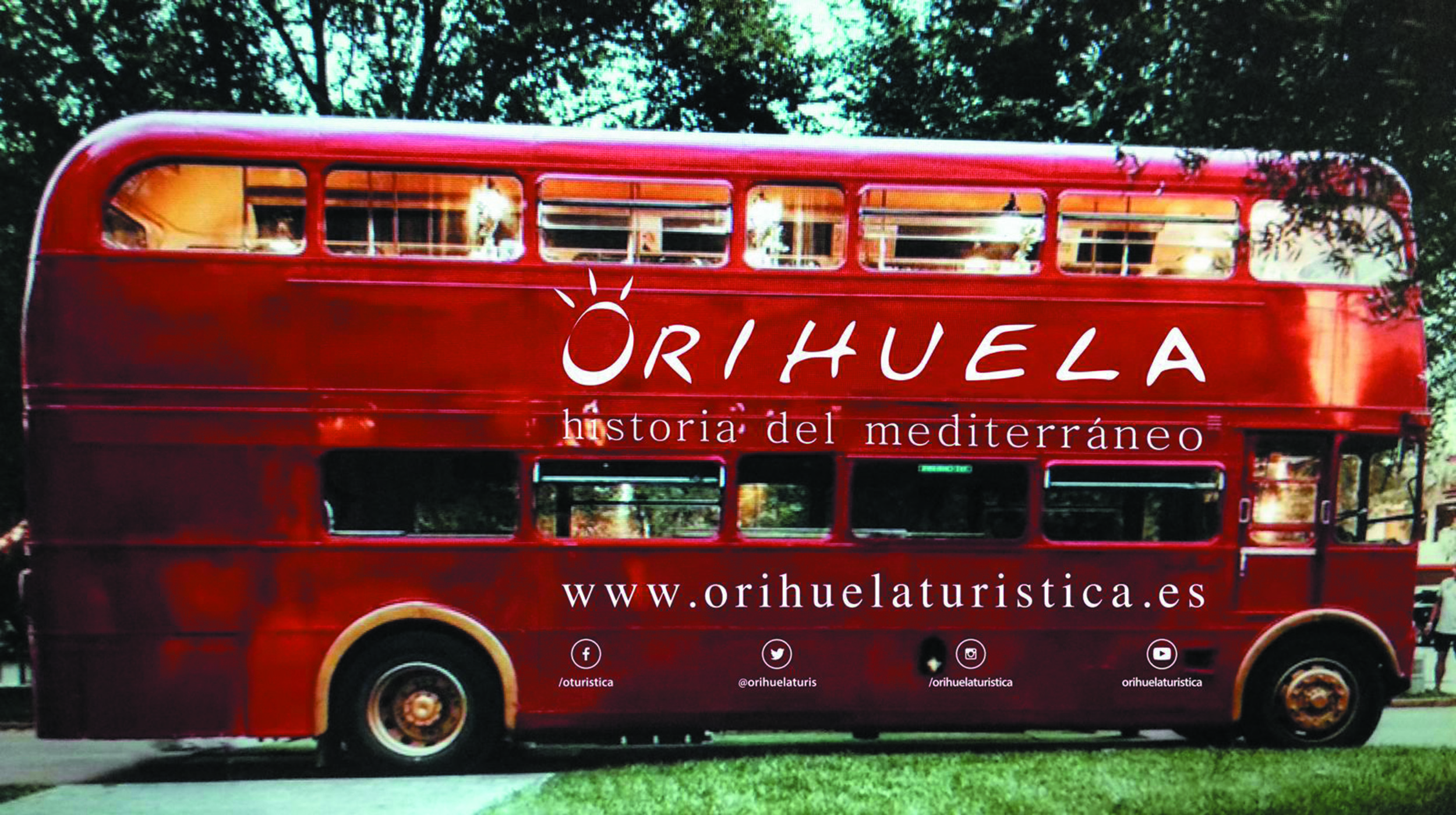 An English tourist bus liveried with the Orihuela brand driving around the centre of Madrid