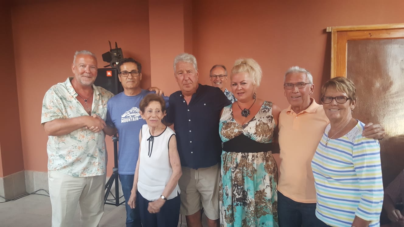 Reporter Andrew Atkinson (left), Los Montesinos Mayor José Butron and guests celebrate at the Social and Cultural centre.