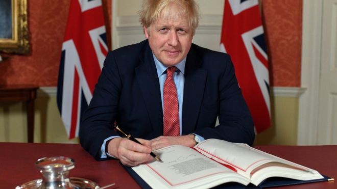 Boris Johnson signing the Brexit withdrawal agreement in Downing Street.
