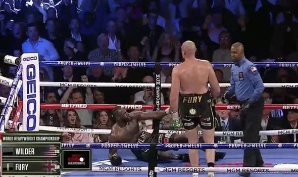 Wilder goes crashing to the canvas as Fury wins the WBC heavyweight title.