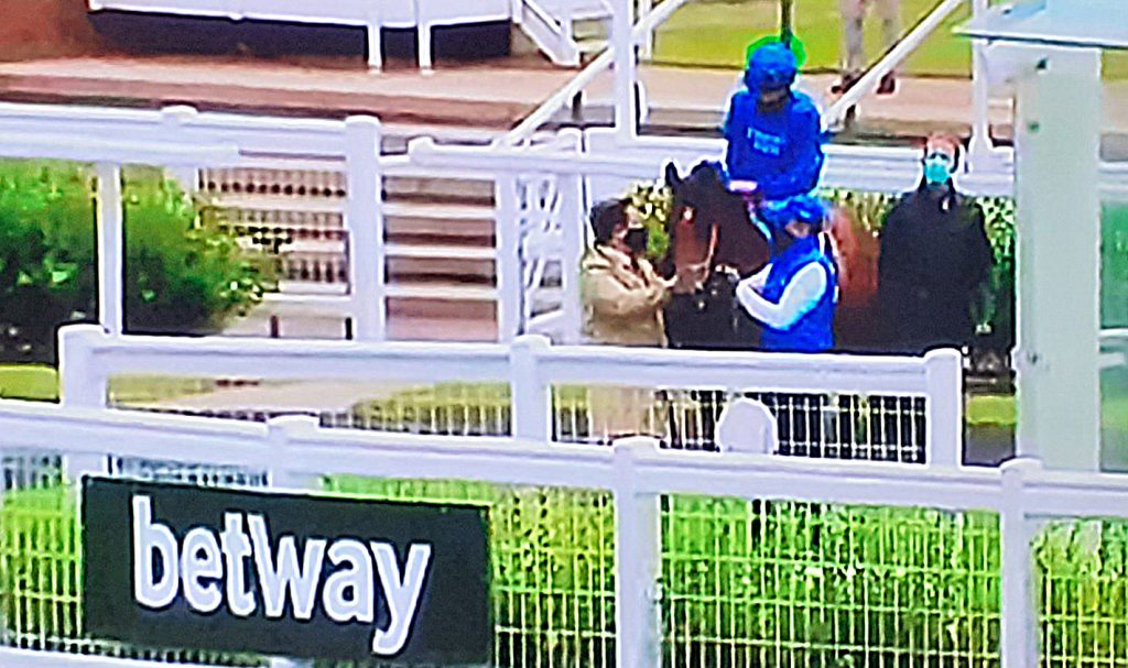 Jockey Buick in the unsaddling enclosure at Newmarket with Boccaccio.